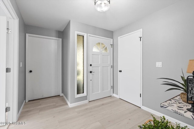 entryway featuring light wood-type flooring and baseboards