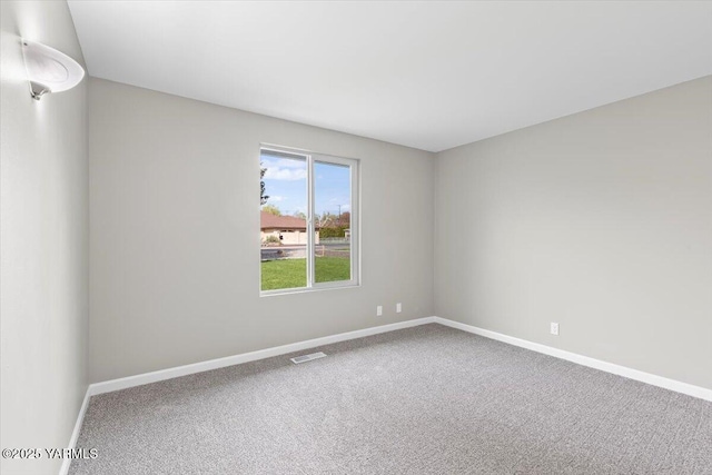 carpeted empty room with baseboards and visible vents