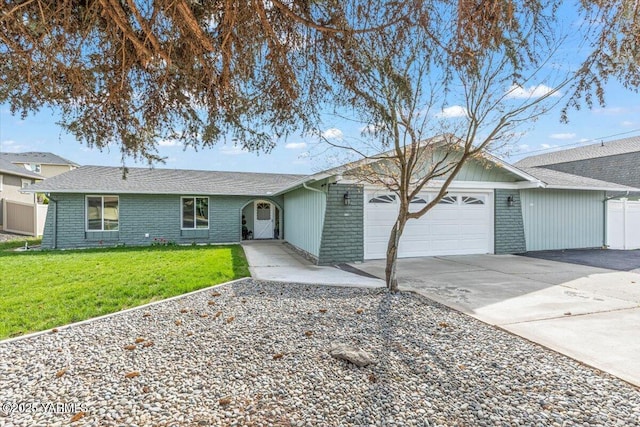 ranch-style home featuring fence, an attached garage, driveway, brick siding, and a front yard