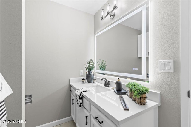 bathroom featuring baseboards and vanity