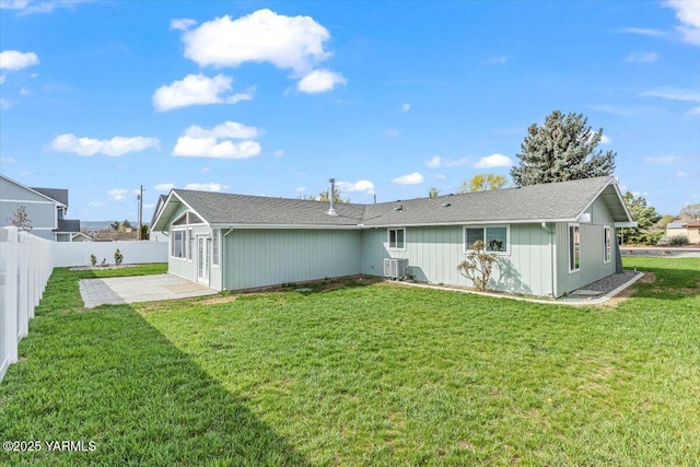 back of house featuring a fenced backyard, a patio area, cooling unit, and a lawn