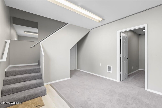 interior space with carpet, visible vents, and baseboards