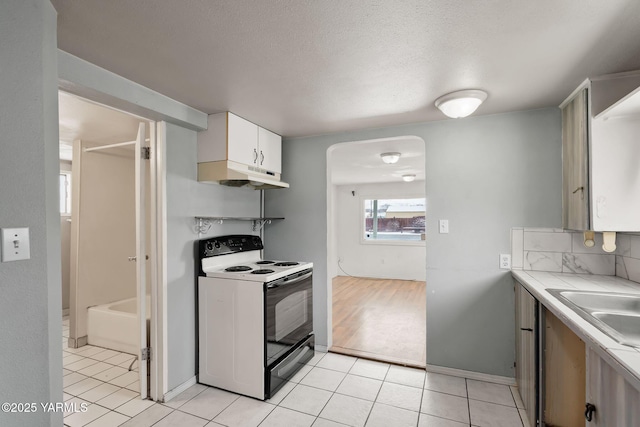 kitchen featuring light tile patterned floors, electric stove, a textured ceiling, under cabinet range hood, and white cabinetry