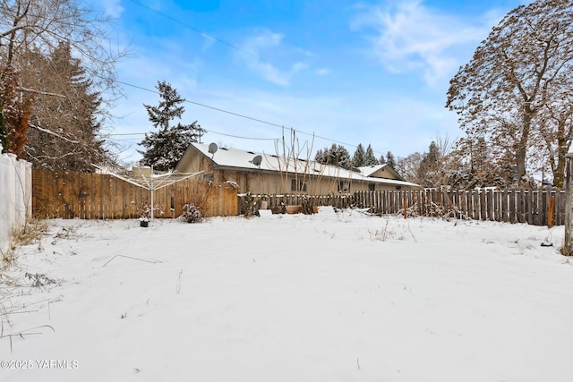 snowy yard with fence