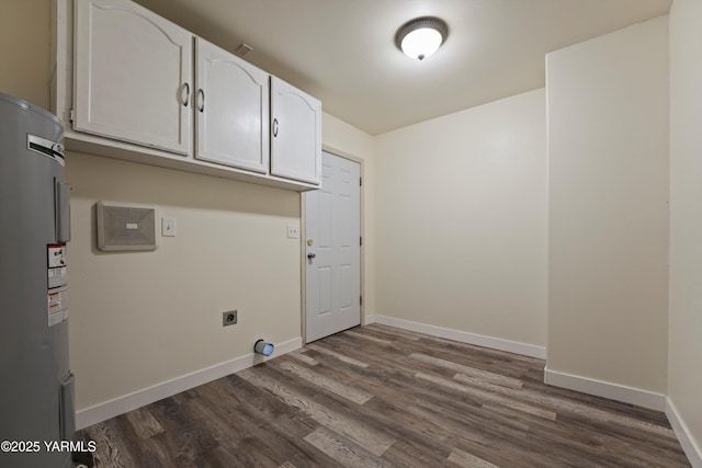 1000 Franklin Rd, Tieton, WA 98947 - washroom featuring water heater, hookup for an electric dryer, cabinet space, dark wood-type flooring, and baseboards