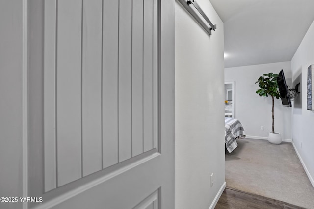 3485 Selah Loop Rd, Selah, WA 98942 - hallway with a barn door, dark wood finished floors, and dark colored carpet