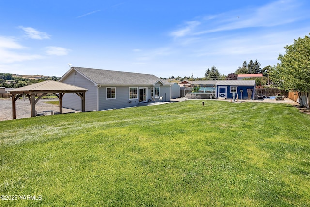 3485 Selah Loop Rd, Selah, WA 98942 - back of property with a gazebo, a fenced backyard, a storage shed, a shingled roof, and a patio area