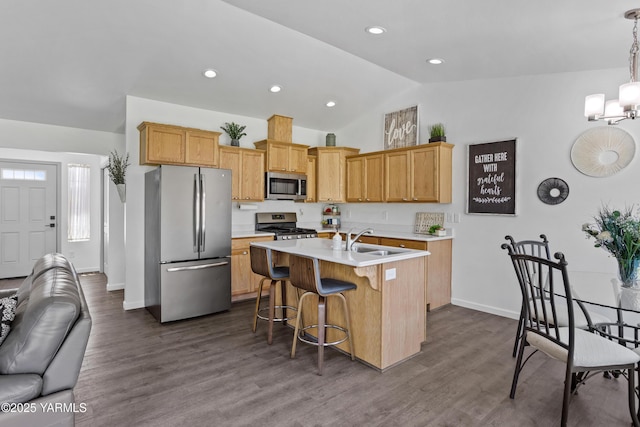 3485 Selah Loop Rd, Selah, WA 98942 - kitchen with stainless steel appliances, vaulted ceiling, light countertops, a kitchen island with sink, and a kitchen bar