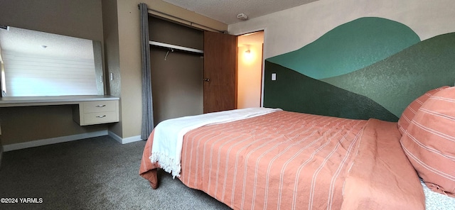 bedroom with carpet, a closet, built in study area, a textured ceiling, and baseboards