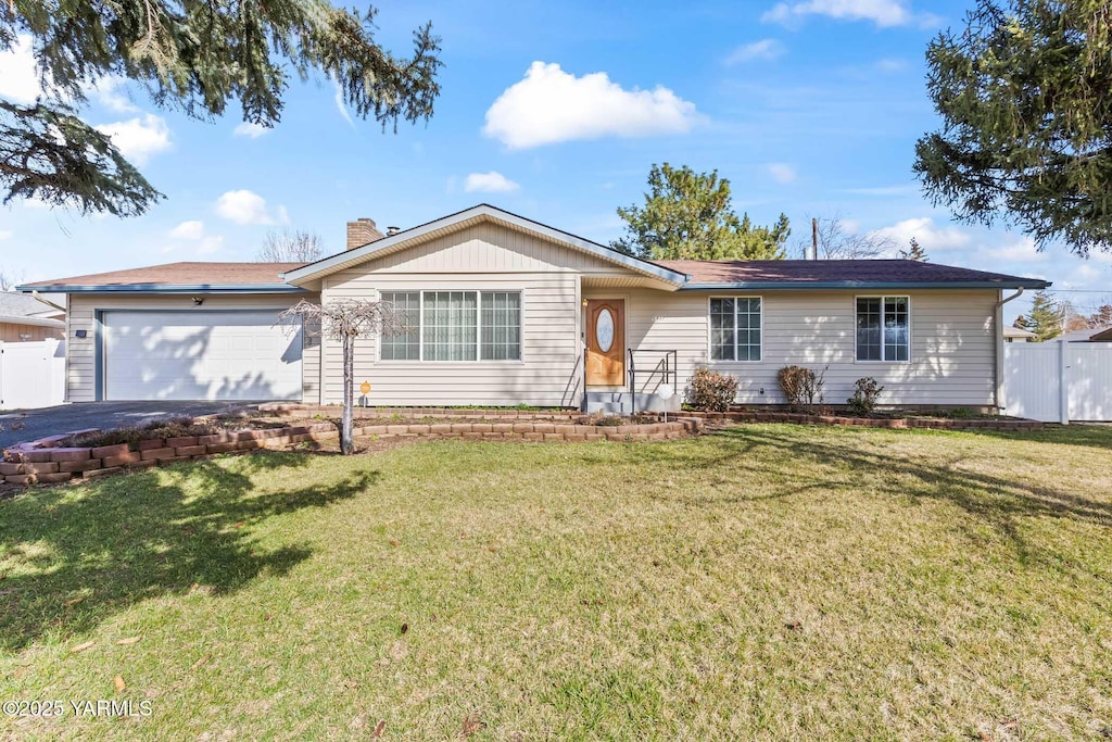 6907 W Chestnut Ave, Yakima, WA 98908 - ranch-style home featuring driveway, a front lawn, an attached garage, and fence