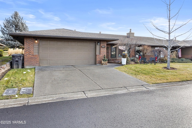 ranch-style home with a front lawn, brick siding, driveway, and an attached garage