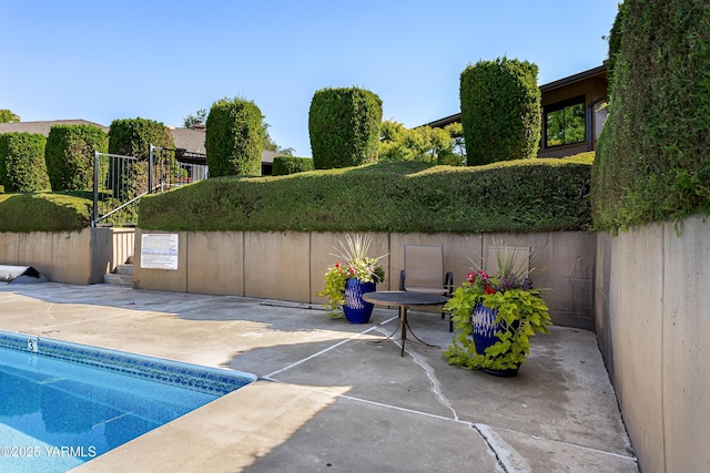 exterior space with fence and a fenced in pool