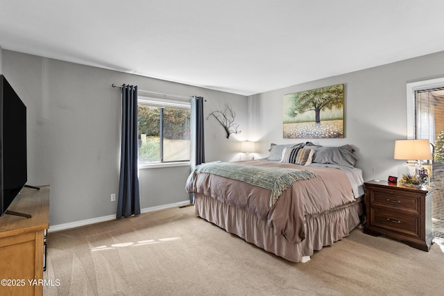 bedroom with light carpet and baseboards