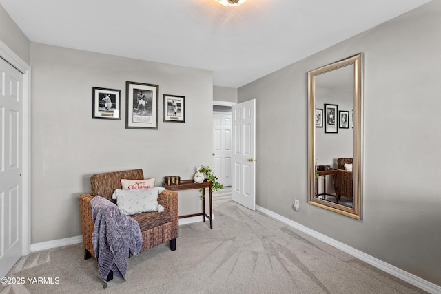 living area with light carpet and baseboards