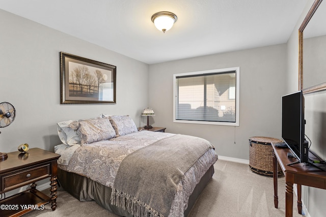 bedroom featuring light carpet and baseboards