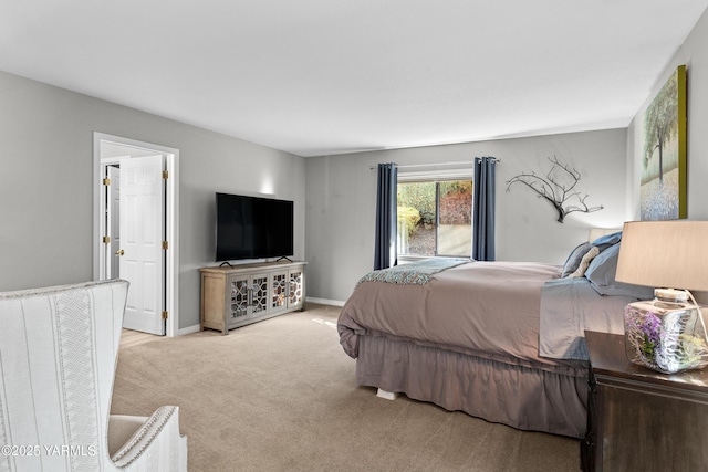 bedroom with light carpet and baseboards