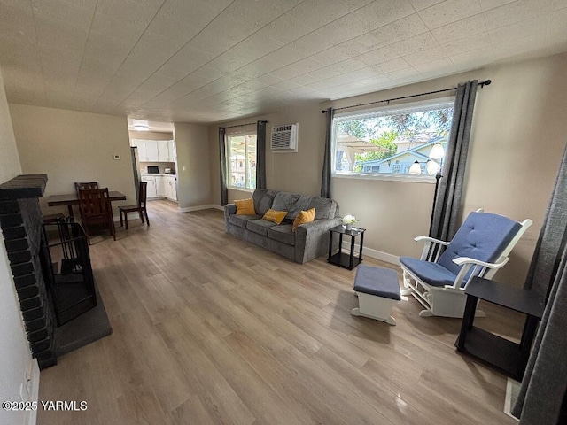 407 S 17th Ave, Yakima, WA 98902 - living room with light wood-style flooring, baseboards, and a wall unit AC