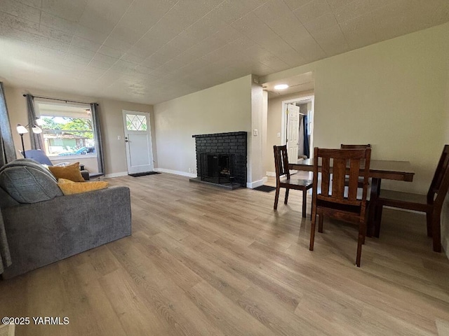 407 S 17th Ave, Yakima, WA 98902 - living area with light wood finished floors, a brick fireplace, and baseboards