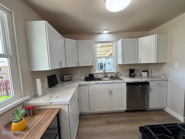 407 S 17th Ave, Yakima, WA 98902 - kitchen featuring stainless steel dishwasher, light wood finished floors, white cabinets, a sink, and baseboards