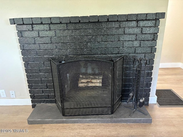 407 S 17th Ave, Yakima, WA 98902 - detailed view of wood finished floors, baseboards, and a fireplace