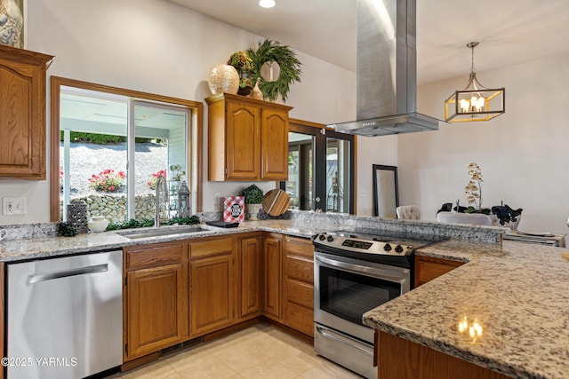 6 N 78th Ave, Yakima, WA 98908 - kitchen featuring stainless steel appliances, island exhaust hood, a chandelier, light stone countertops, and brown cabinetry