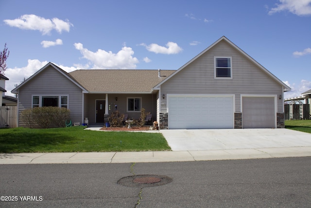 408 S 93rd Ave, Yakima, WA 98908 - view of front of house featuring a garage, stone siding, a front yard, a shingled roof, and driveway