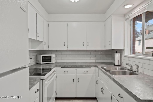 1501 W Chestnut Ave Unit 5, Yakima, WA 98902 - kitchen featuring white appliances, white cabinetry, and decorative backsplash