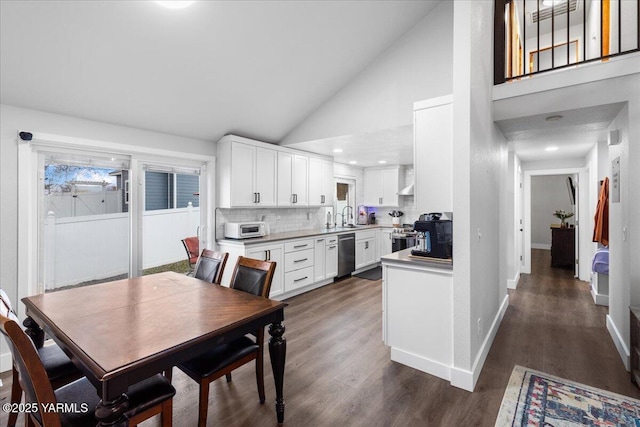 dining room with high vaulted ceiling, baseboards, and dark wood-style flooring