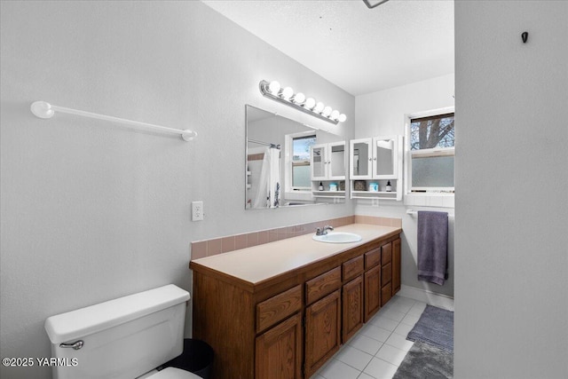 full bath featuring vanity, tile patterned floors, toilet, and a shower with curtain