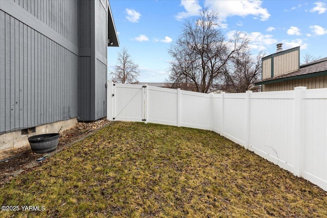 view of yard featuring a fenced backyard and a gate