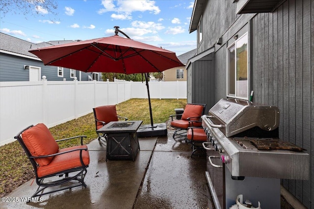 view of patio with a fire pit and a fenced backyard