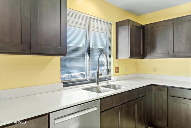 kitchen featuring dark brown cabinetry, light countertops, a sink, and stainless steel dishwasher