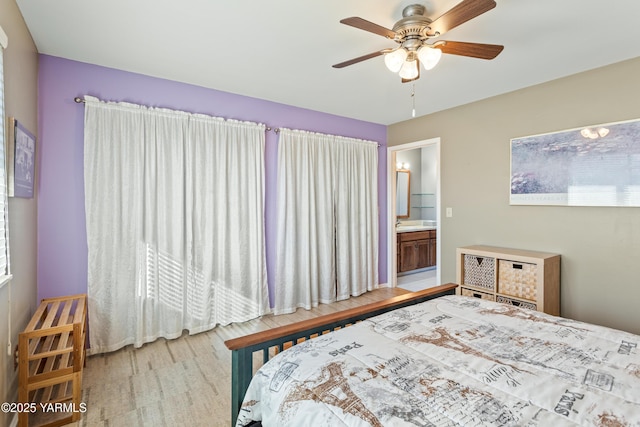 bedroom with light wood-type flooring, connected bathroom, and ceiling fan