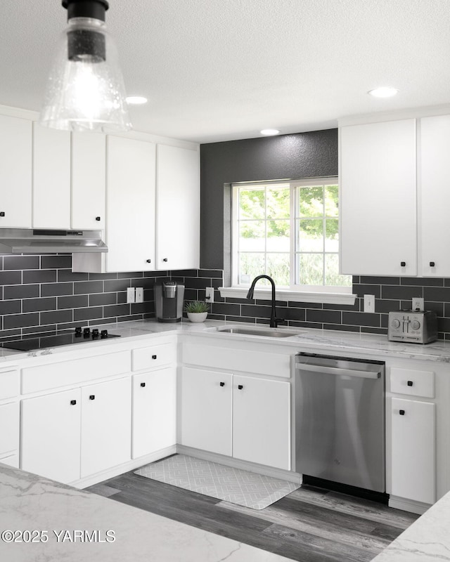 15014 Fisk Rd, Yakima, WA 98908 - kitchen with stainless steel dishwasher, a sink, black electric cooktop, under cabinet range hood, and decorative backsplash