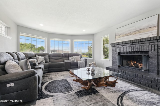 15014 Fisk Rd, Yakima, WA 98908 - living area featuring a brick fireplace, healthy amount of natural light, recessed lighting, and wood finished floors