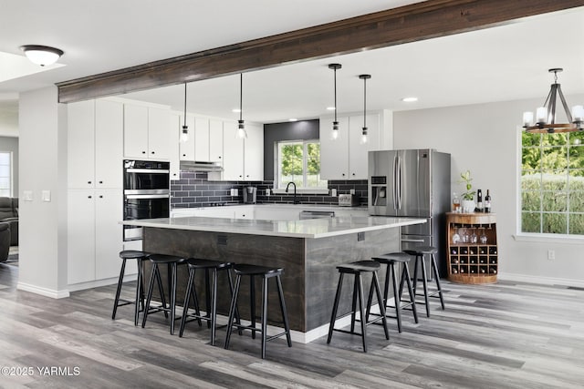 15014 Fisk Rd, Yakima, WA 98908 - kitchen featuring stainless steel appliances, baseboards, light wood finished floors, tasteful backsplash, and recessed lighting