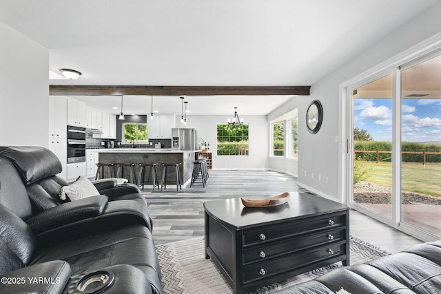 15014 Fisk Rd, Yakima, WA 98908 - living room with light wood-style floors, beamed ceiling, and baseboards