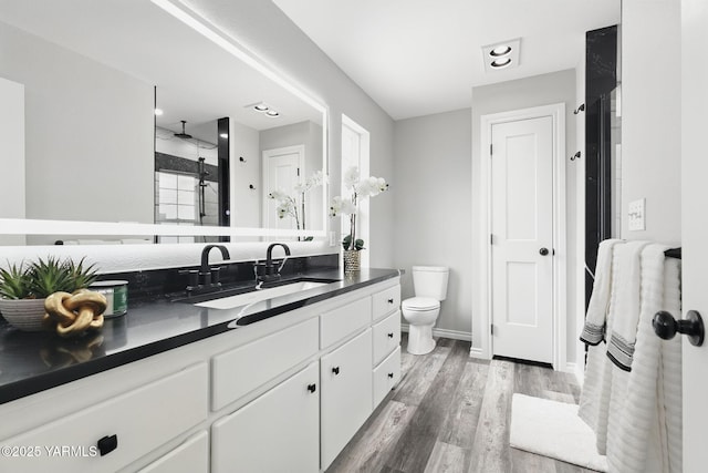 15014 Fisk Rd, Yakima, WA 98908 - full bath featuring vanity, a shower with shower door, wood finished floors, toilet, and baseboards