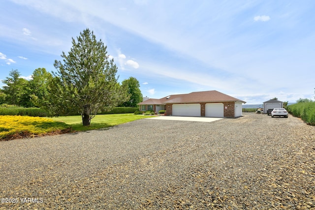 15014 Fisk Rd, Yakima, WA 98908 - view of front of house featuring driveway, brick siding, a garage, and a front lawn