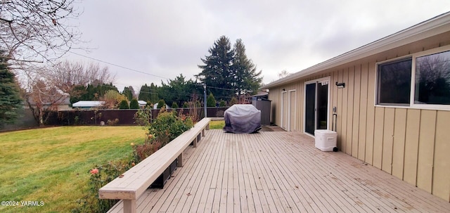 wooden deck with a yard and a fenced backyard