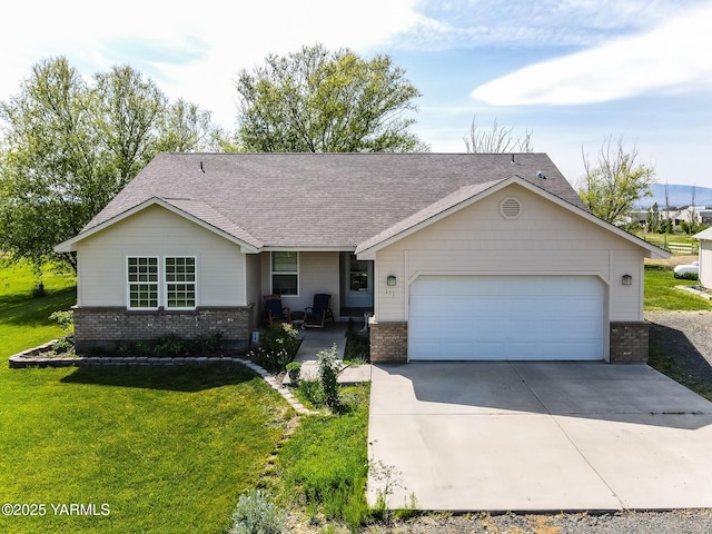 131 Latigo Ln, Yakima, WA 98901 - single story home featuring brick siding, concrete driveway, a front lawn, and a garage