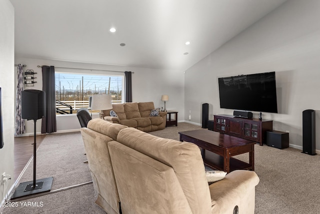 carpeted living area with recessed lighting, baseboards, and high vaulted ceiling