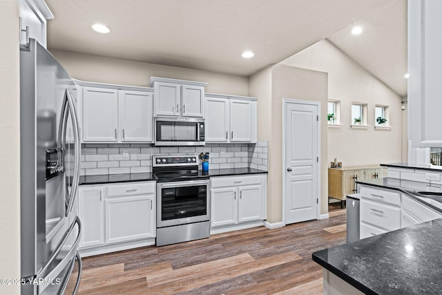 kitchen featuring backsplash, light wood-style flooring, white cabinets, and stainless steel appliances