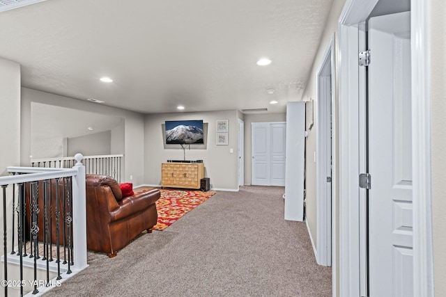 carpeted living area featuring recessed lighting and baseboards