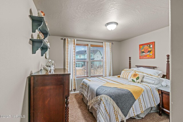 bedroom featuring carpet and a textured ceiling