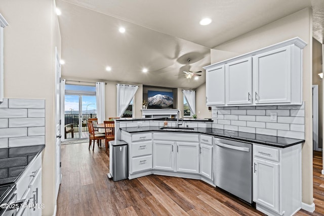 kitchen with a sink, dark countertops, stainless steel appliances, white cabinets, and dark wood-style flooring