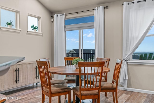 dining area with light wood finished floors and baseboards