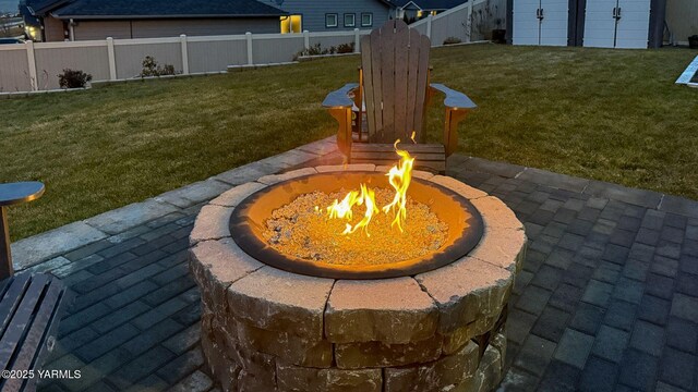 view of yard featuring an outdoor fire pit and fence