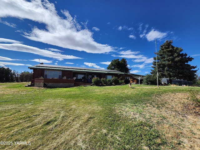 13520 Fisk Rd, Yakima, WA 98908 - back of property with a lawn and a wooden deck