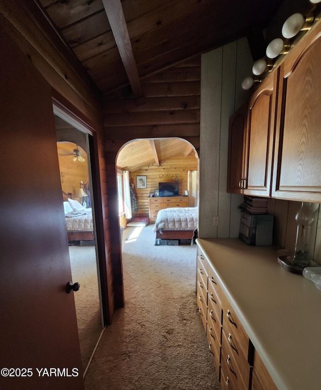13520 Fisk Rd, Yakima, WA 98908 - carpeted bedroom featuring wooden walls, wooden ceiling, and arched walkways